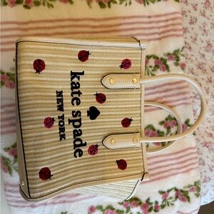 kate spade Cream Straw Tote with Red Ladybug Motif